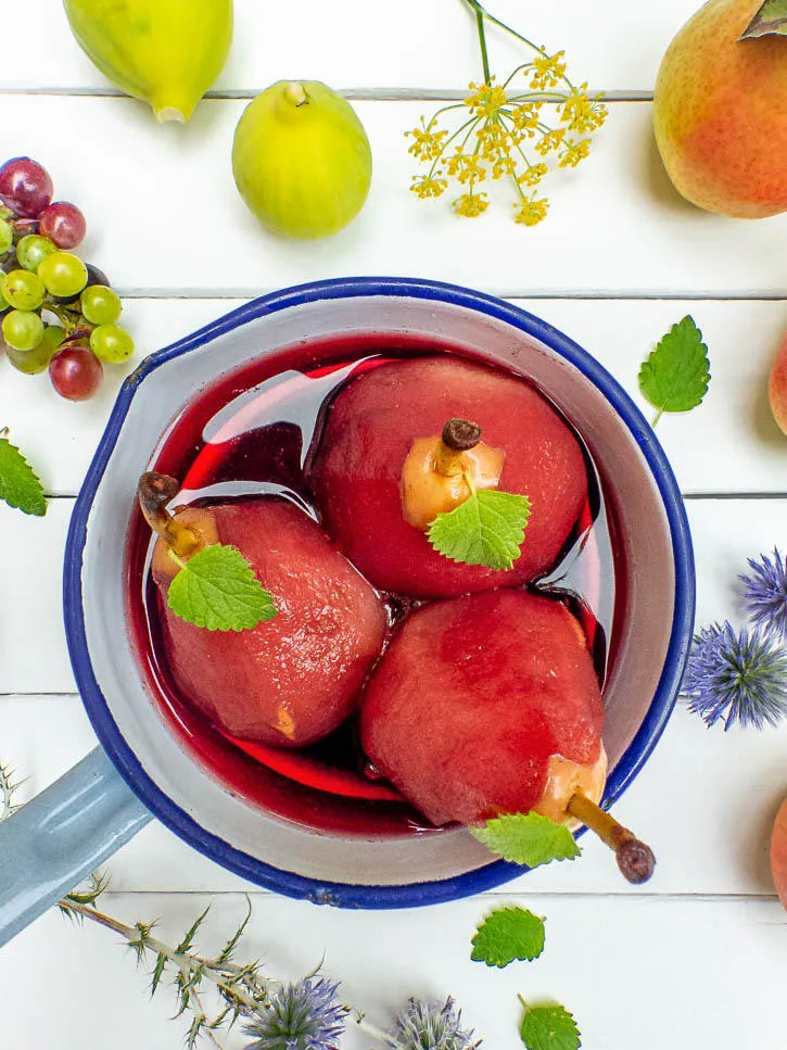 Poires pochées à l’hibiscus, cardamome et baies roses